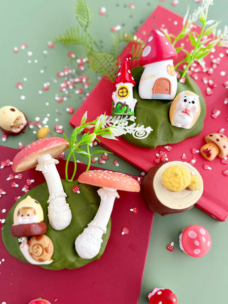 Decorative wreath with small figures and mushrooms on a green and red background