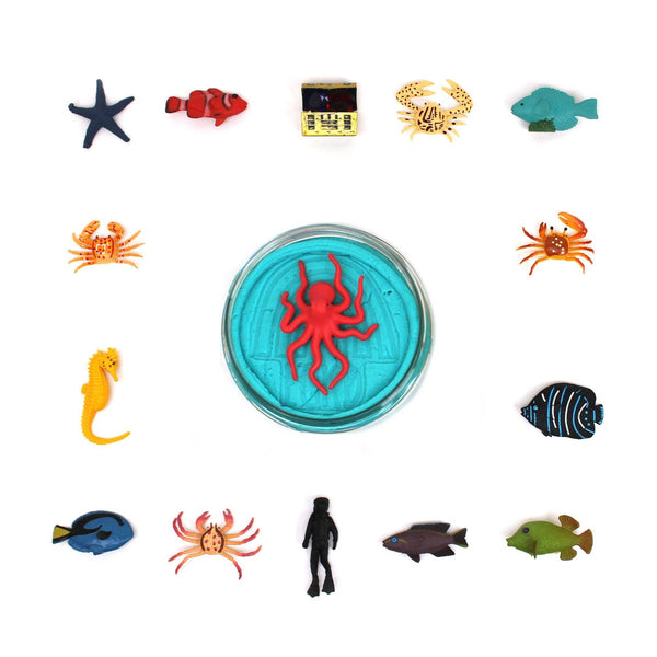 Collection of colorful sea-themed toys around a central container with a red spider design.
