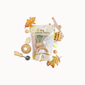 A KidDough Play Kit themed around pies, shown in a clear plastic bag with autumn-themed props like cookie cutters, dough balls, and pie crust on a solid white background.