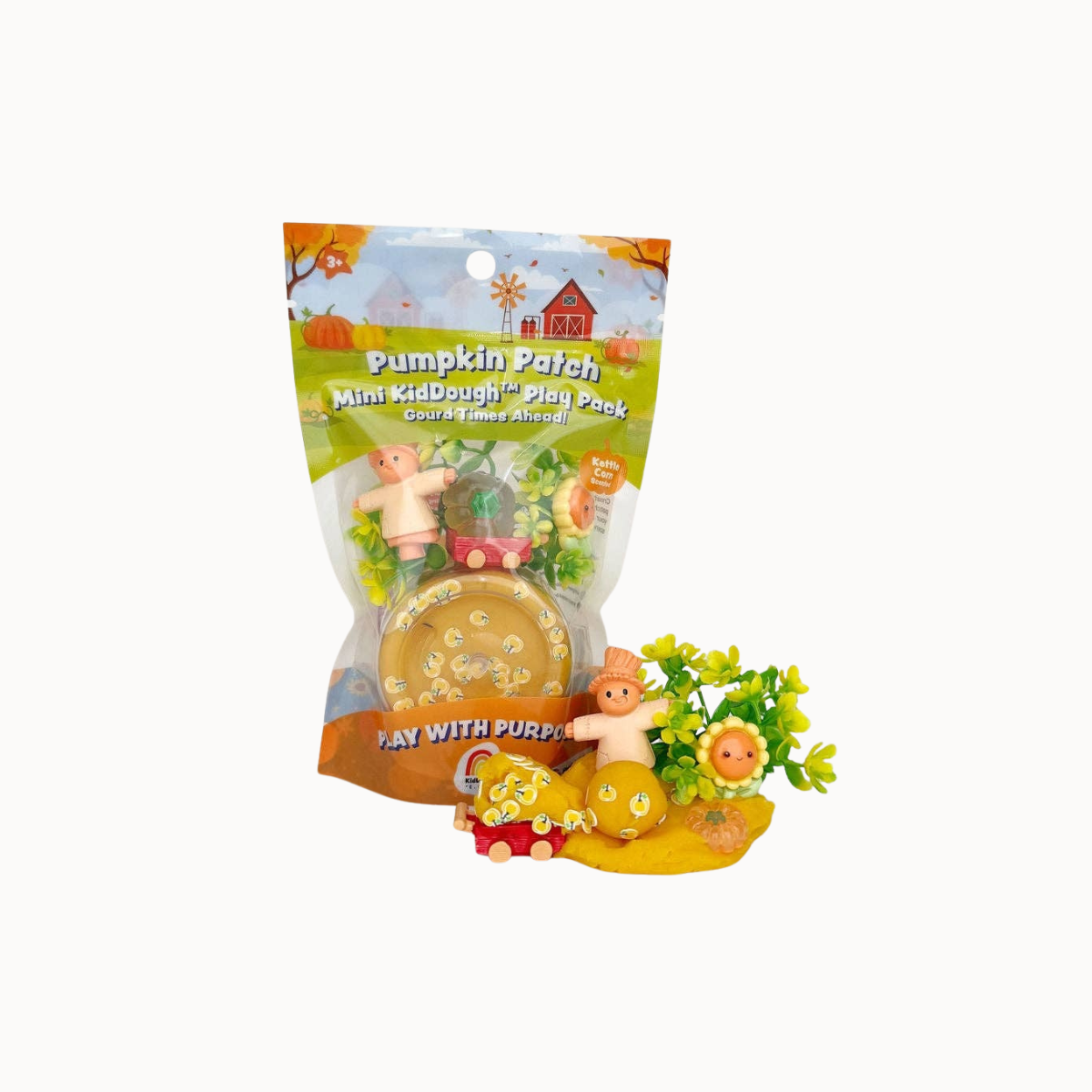 Pumpkin Patch Mini KidDough Play Pack, featuring a clear plastic bag with a colorful autumn-themed label and several small wooden toy pieces displayed in front on a white background.