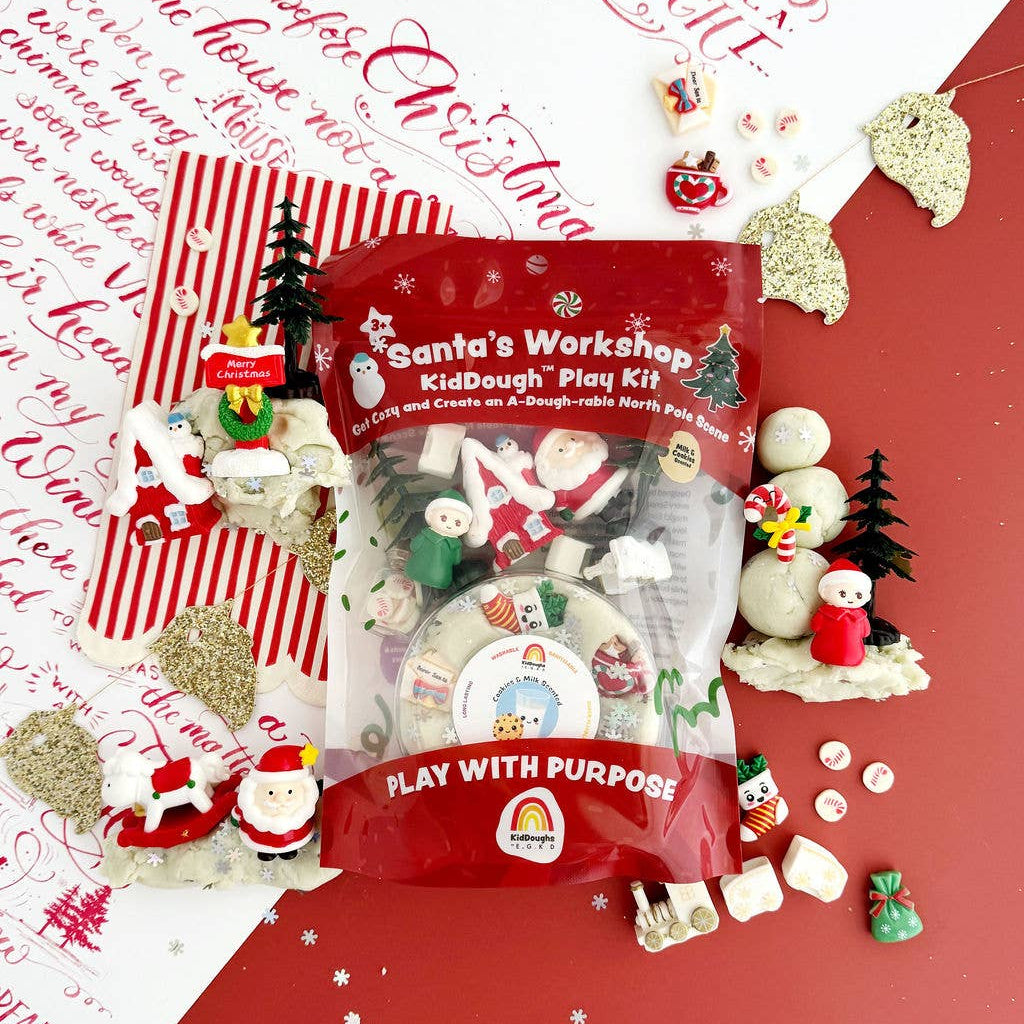 Santa's Workshop Kiddough Play Kit on a red background with Christmas-themed decorations.