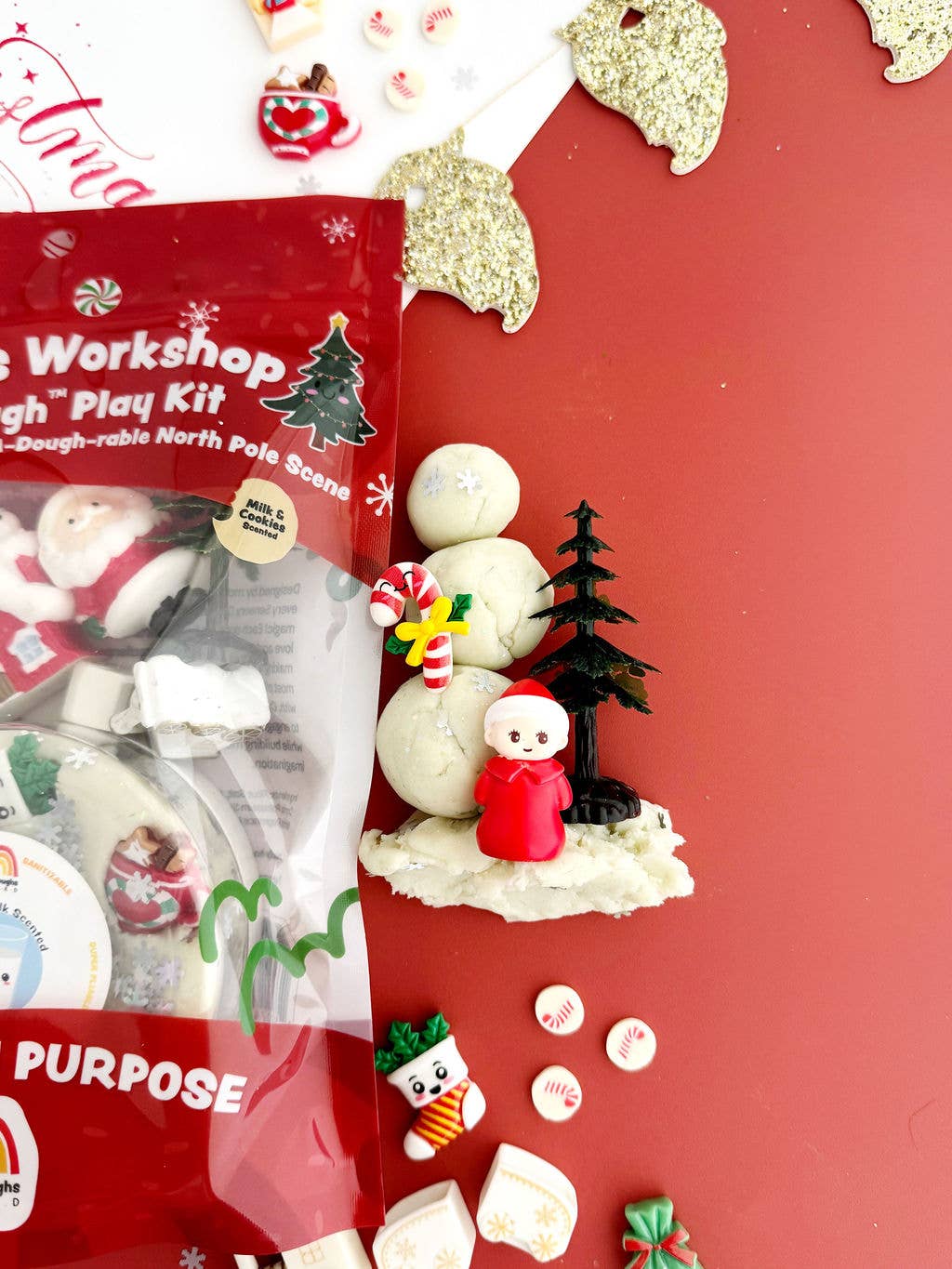Christmas-themed play dough kit with figures on a red background
