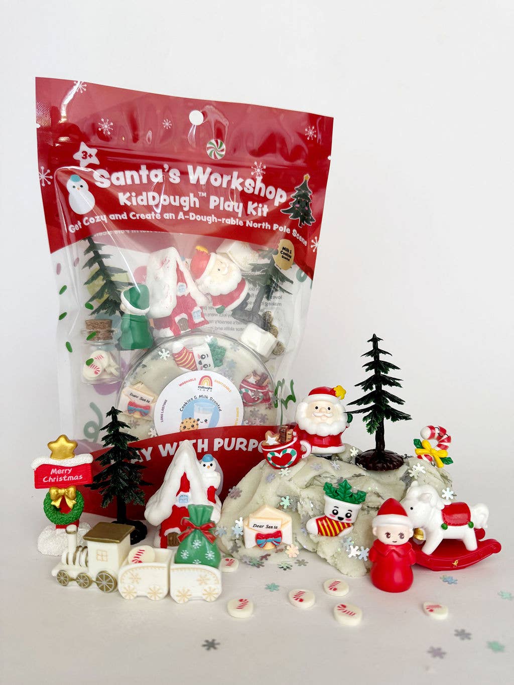 Christmas-themed play kit with figures and packaging labeled 'Santa's Workshop' on a white background.