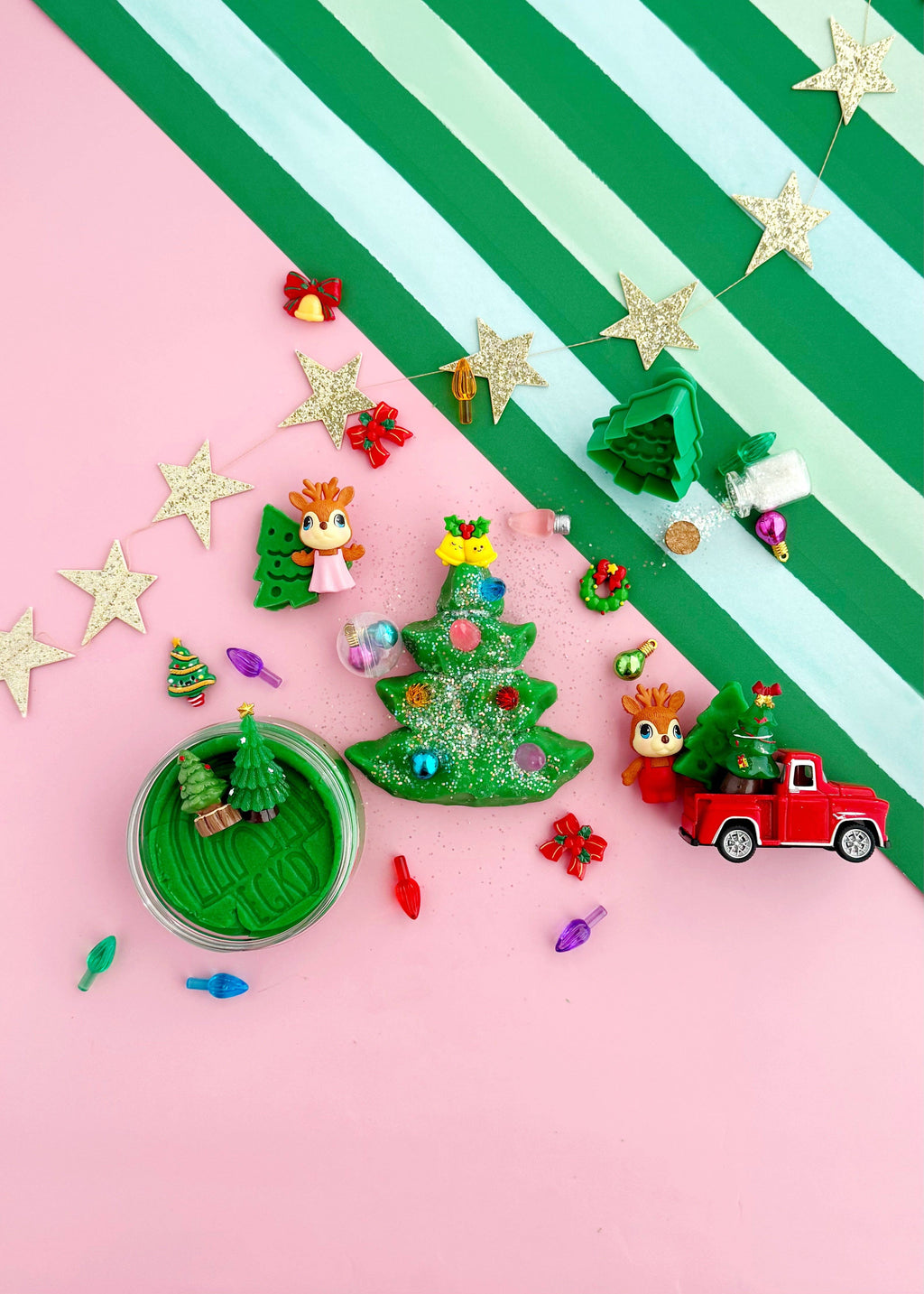 Colorful Christmas-themed decorations on a pink and green striped background