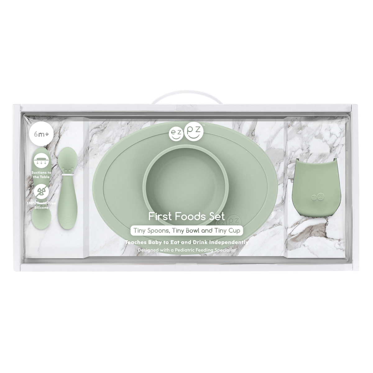 Mint green baby feeding set with bowl, spoon, and cup in packaging on a white background