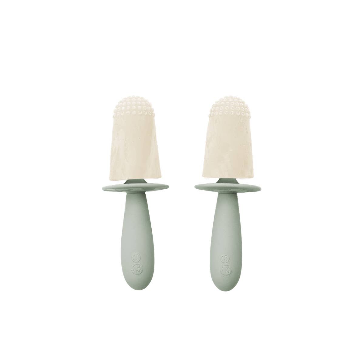 Two green baby soothers with beige silicone teats on a white background