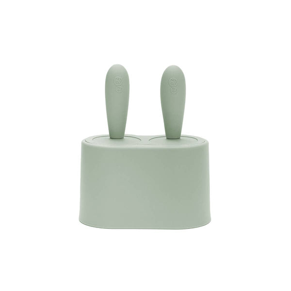Sage green ice cream mold with two handles on a white background