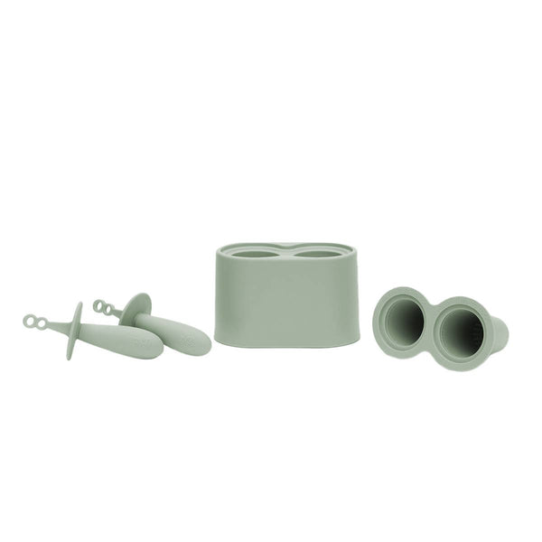 Set of green silicone kitchen tools on a white background
