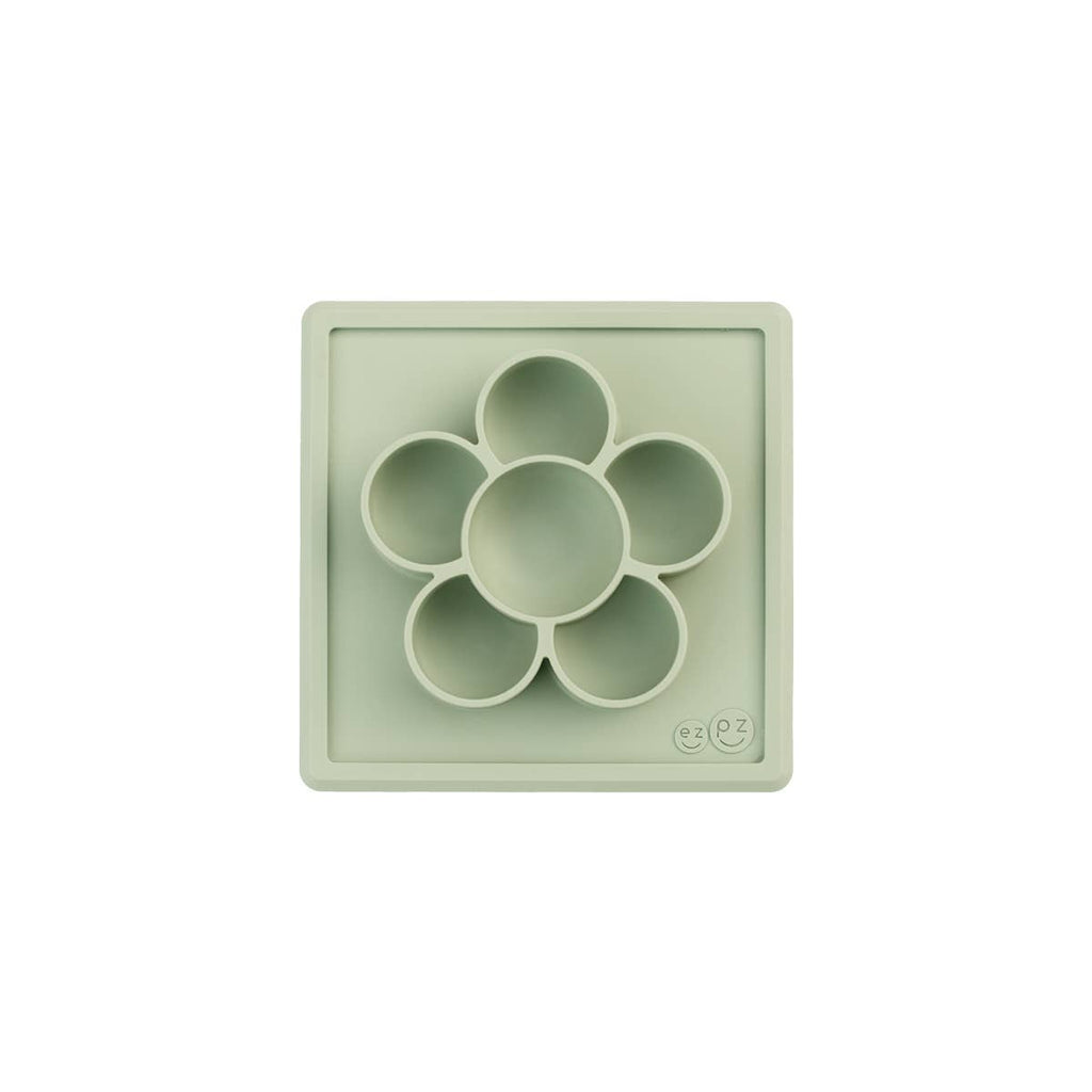 Light green silicone mold with circular compartments on a white background