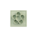 Light green silicone mold with circular compartments on a white background