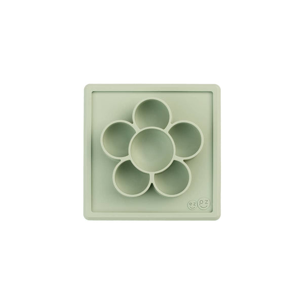 Light green silicone mold with circular compartments on a white background