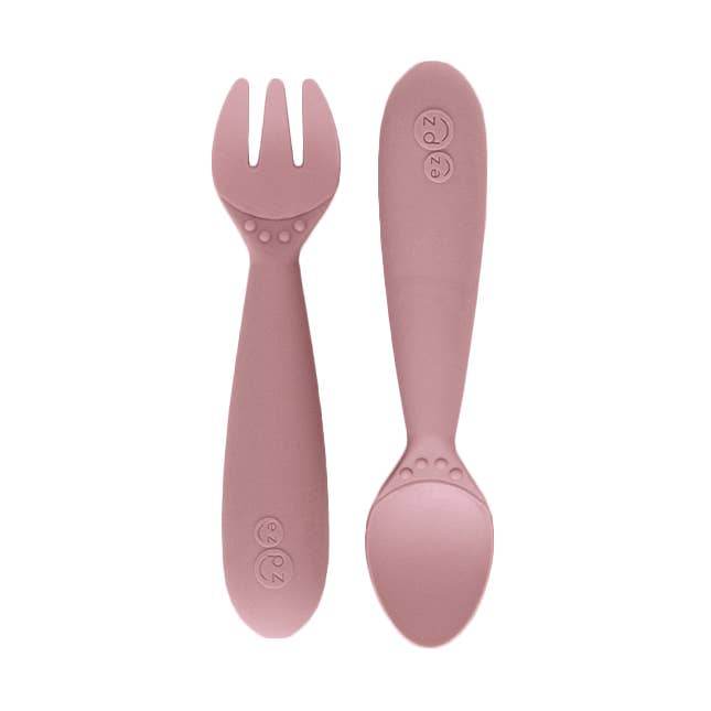 Pink fork and spoon set on a white background
