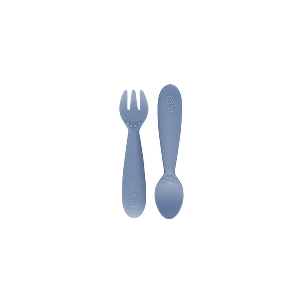 Packaged mini utensils consisting of a fork and spoon designed for toddlers, with a gray color and sensory features.