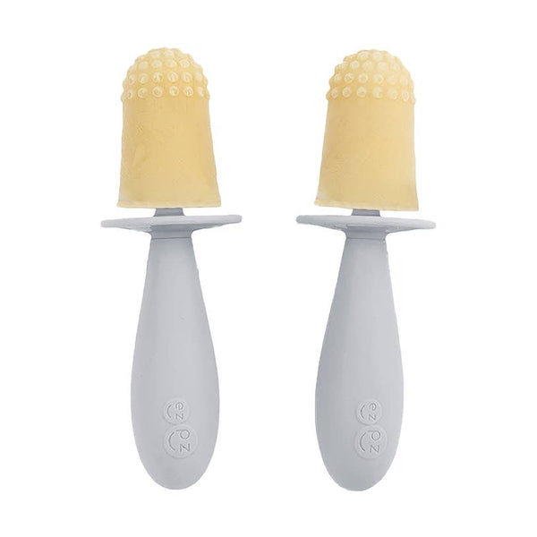 Two baby soothers with yellow silicone tips on a white background