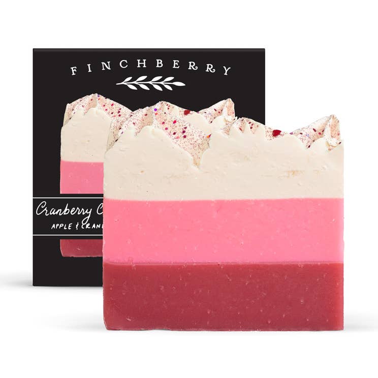 Two layered soap bars with a black Finchberry packaging in the background