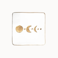 A square white tray with a thin gold border, featuring a gold foil moon phase design across the center.