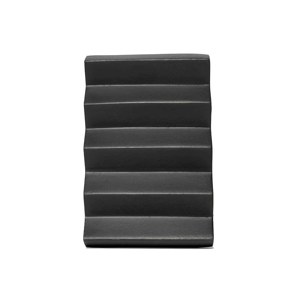 Black wedge-shaped product on a white background