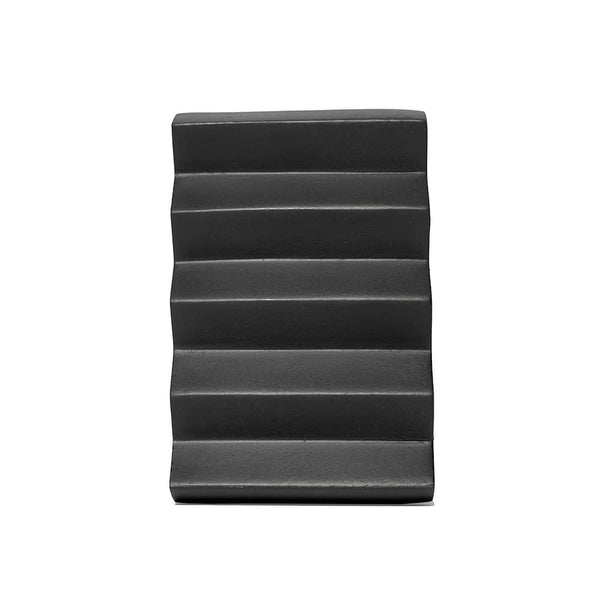 Black wedge-shaped product on a white background