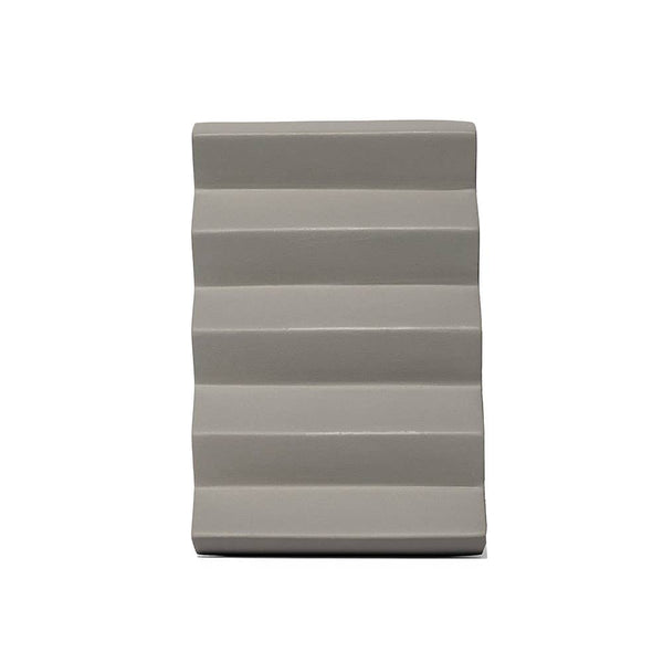 Rectangular wedge-shaped pillow with striped pattern on a white background
