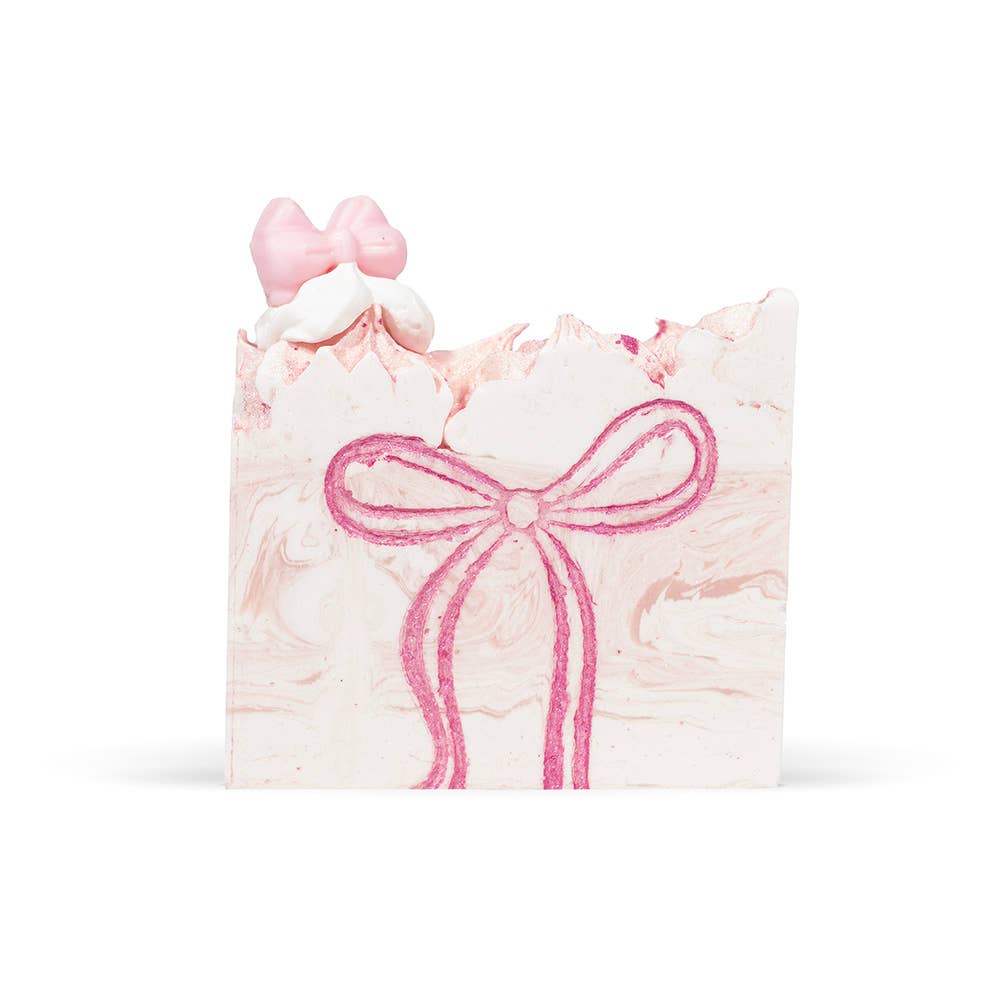 Pink soap bar with a bow design on a white background