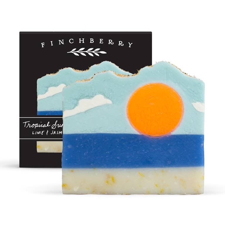 Decorative soap with mountain and sun design in front of a Finchberry branded box.