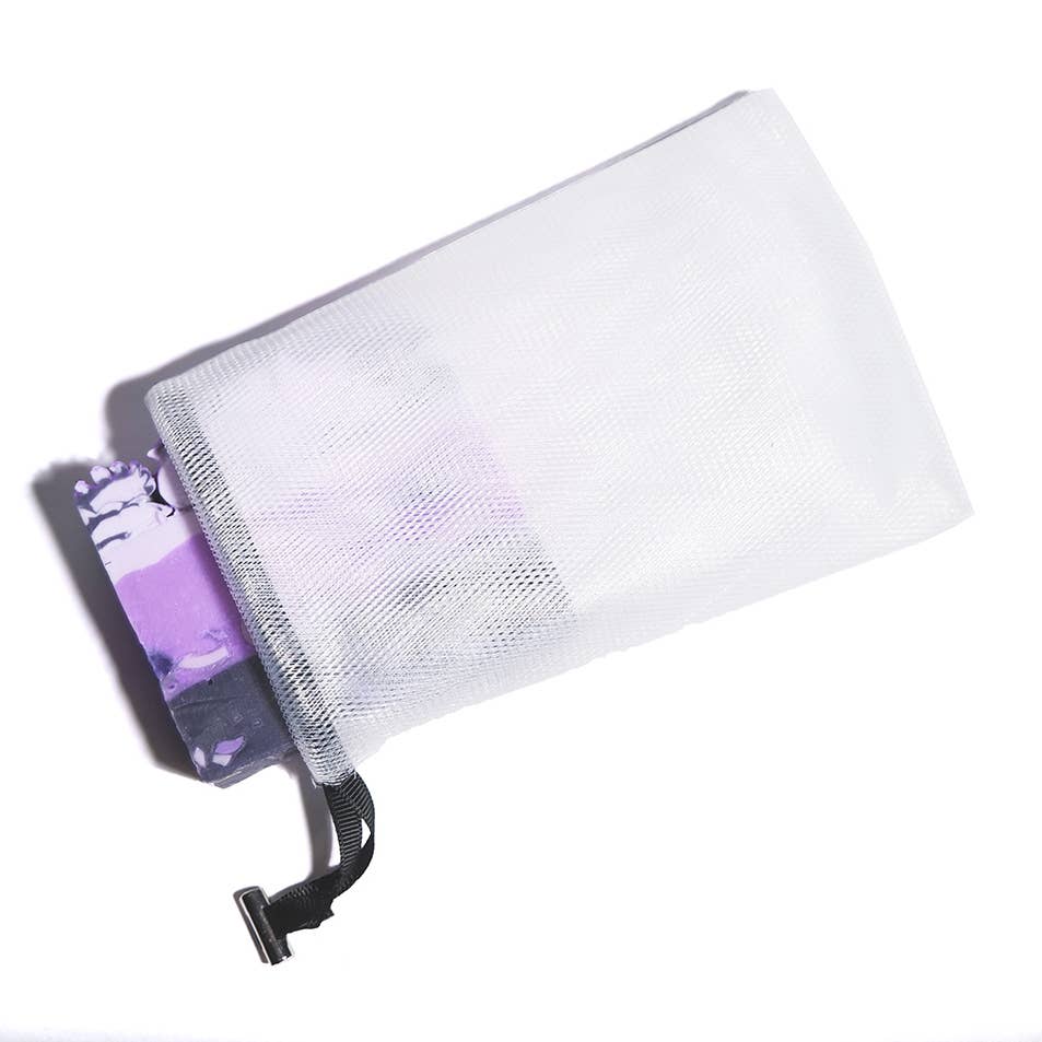 White mesh pouch with a purple item partially visible inside on a white background