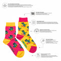 Colorful socks with dinosaur pattern on a white background with greenery and text about sustainability.