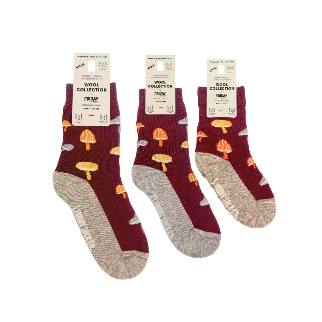 Three pairs of maroon socks with mushroom pattern on a white background