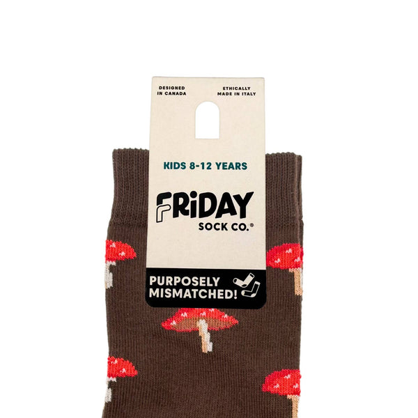 Pair of brown socks with red mushroom patterns on a white background, featuring 'Friday Sock Co.' packaging.