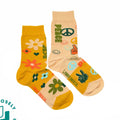 Two pairs of socks with peace signs and floral designs on a white background.
