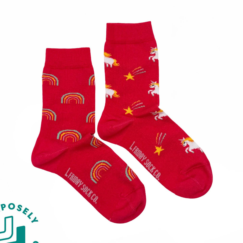 Red socks with unicorn and rainbow patterns on a white background