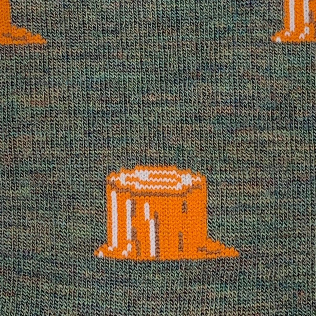 Textured green fabric with orange and white pattern