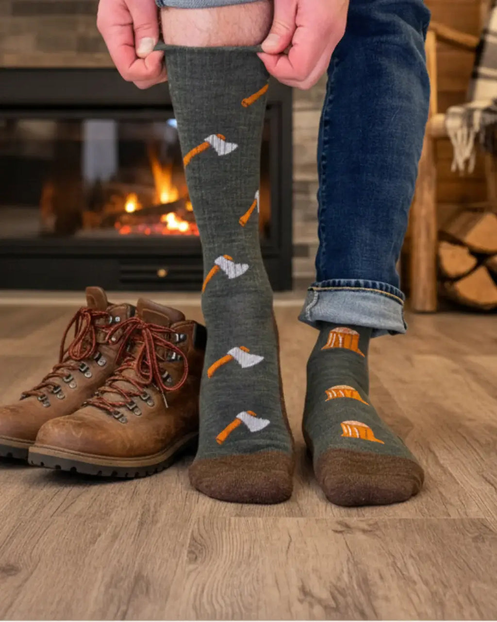 Person wearing patterned socks with tools and brown boots in front of a fireplace.