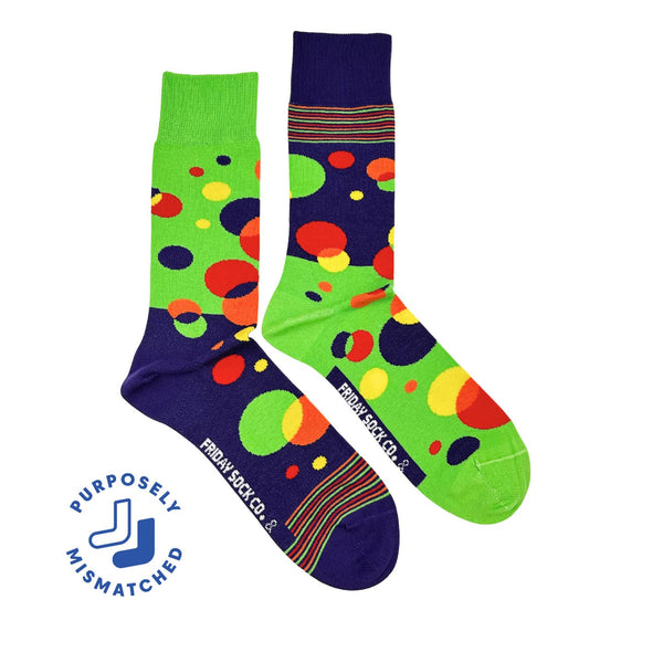 Two colorful socks with polka dot pattern on a white background, featuring the brand 'Purposely Mismatched'.