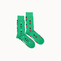 A pair of bright green crew socks with a repeating pattern of toy soldiers in black, red, and white, displayed on a clean off-white background.