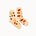 A pair of cream-colored crew socks with a colorful autumn-themed print featuring pumpkins, acorns, leaves, and stars, displayed against a solid off-white background.