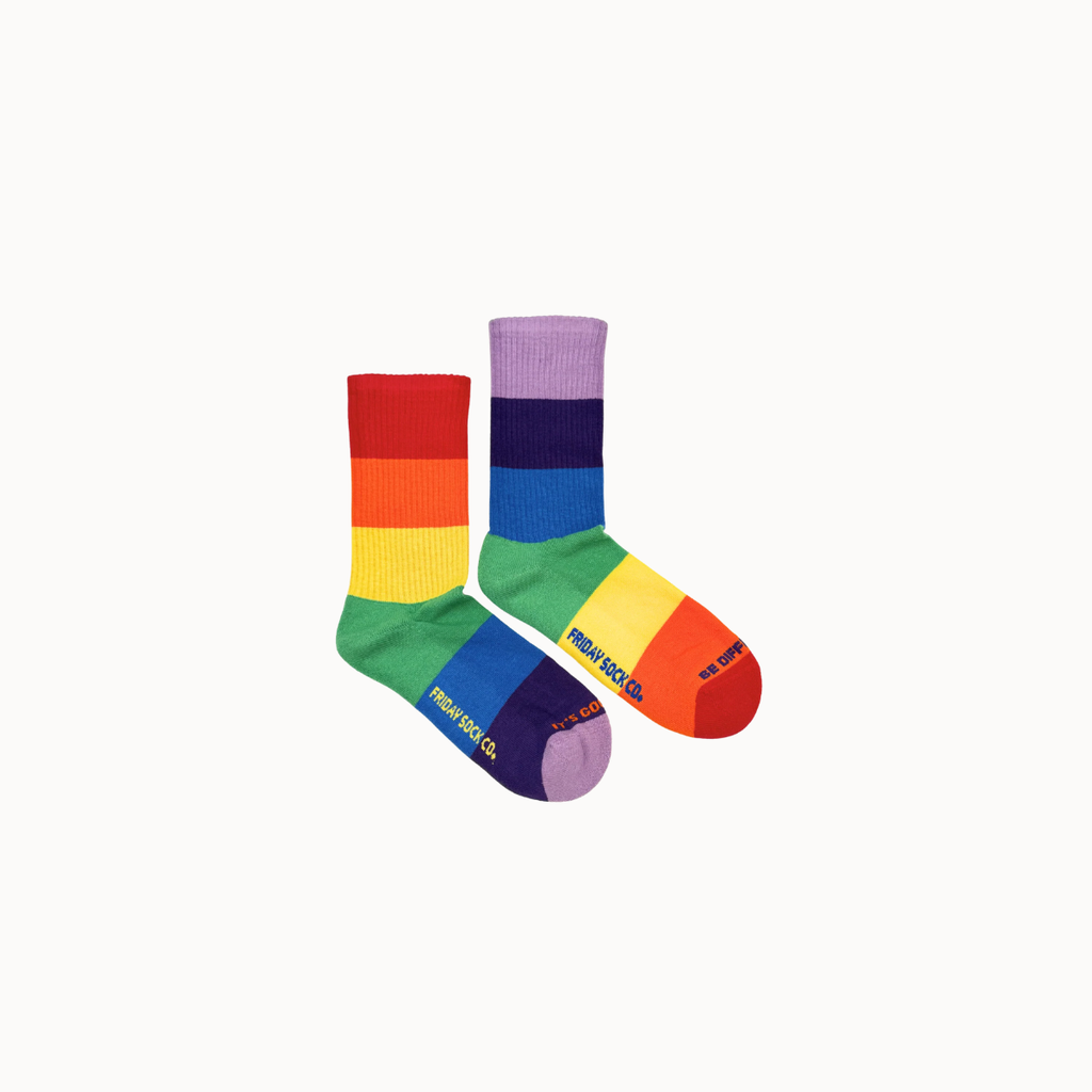 Two rainbow-striped crew socks with the brand name 'MIND ROCK LIFE' printed on them, displayed against a solid off-white background.