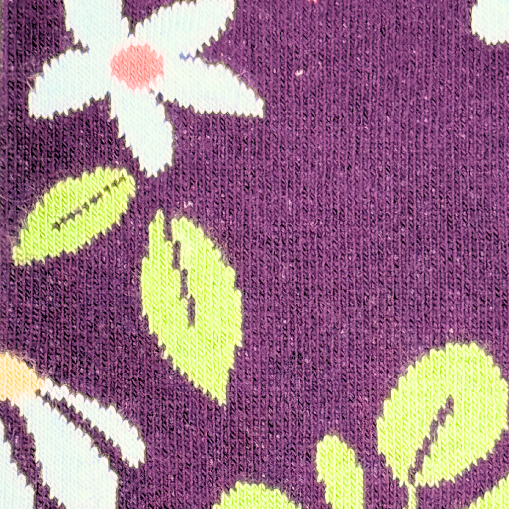Floral pattern with white flowers and green leaves on a purple background