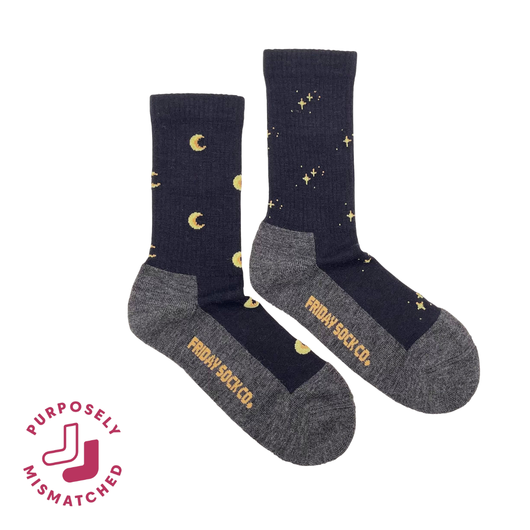 Two pairs of mismatched socks with celestial designs on a white background, featuring the brand 'Friday Sock Co.'