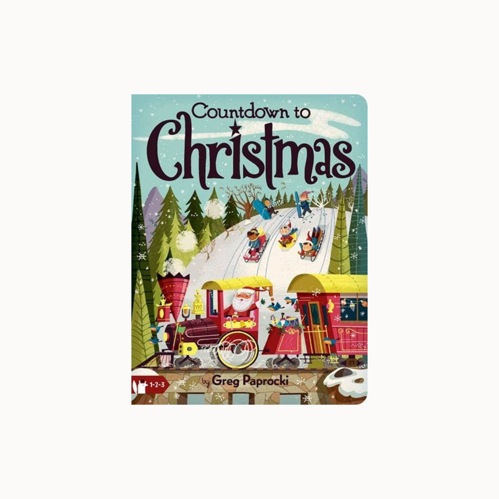 Countdown to Christmas board game by Greg Paprocki, featuring a colorful winter illustration with a train, Santa, and children sledding on a snowy hill.