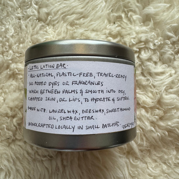 Small metal container with a label on a fluffy white surface
