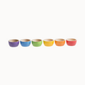 A set of six wooden bowls in a rainbow color palette, displayed in a row.