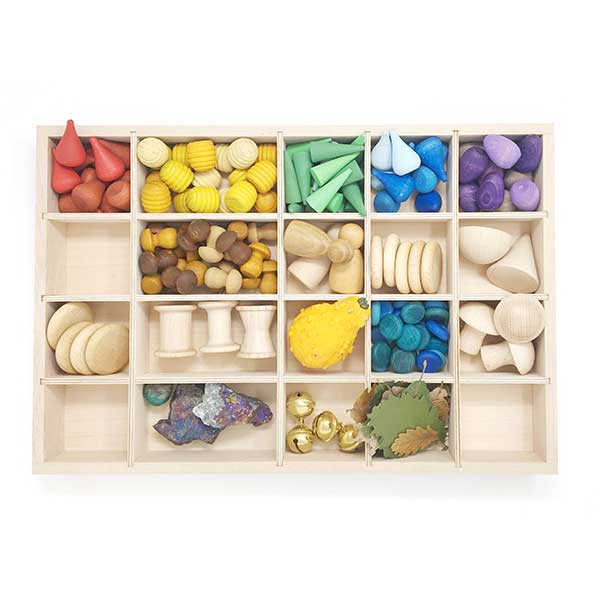 Wooden toy sorting box with various colored wooden shapes on a white background