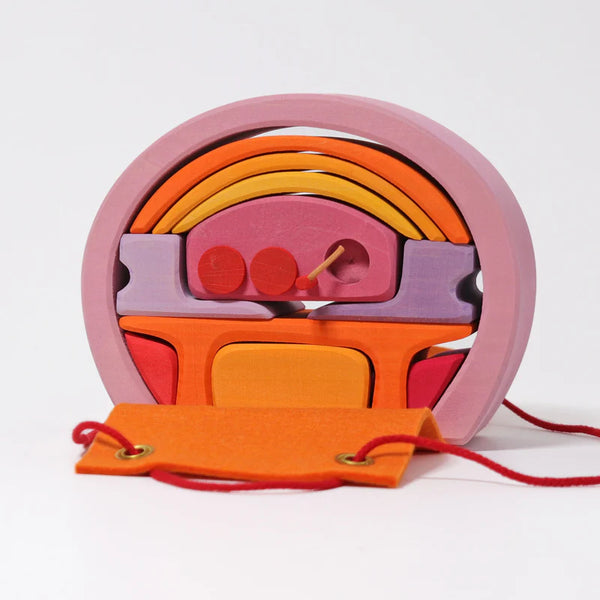 Colorful wooden toy with a pink, orange, and purple design on a white background