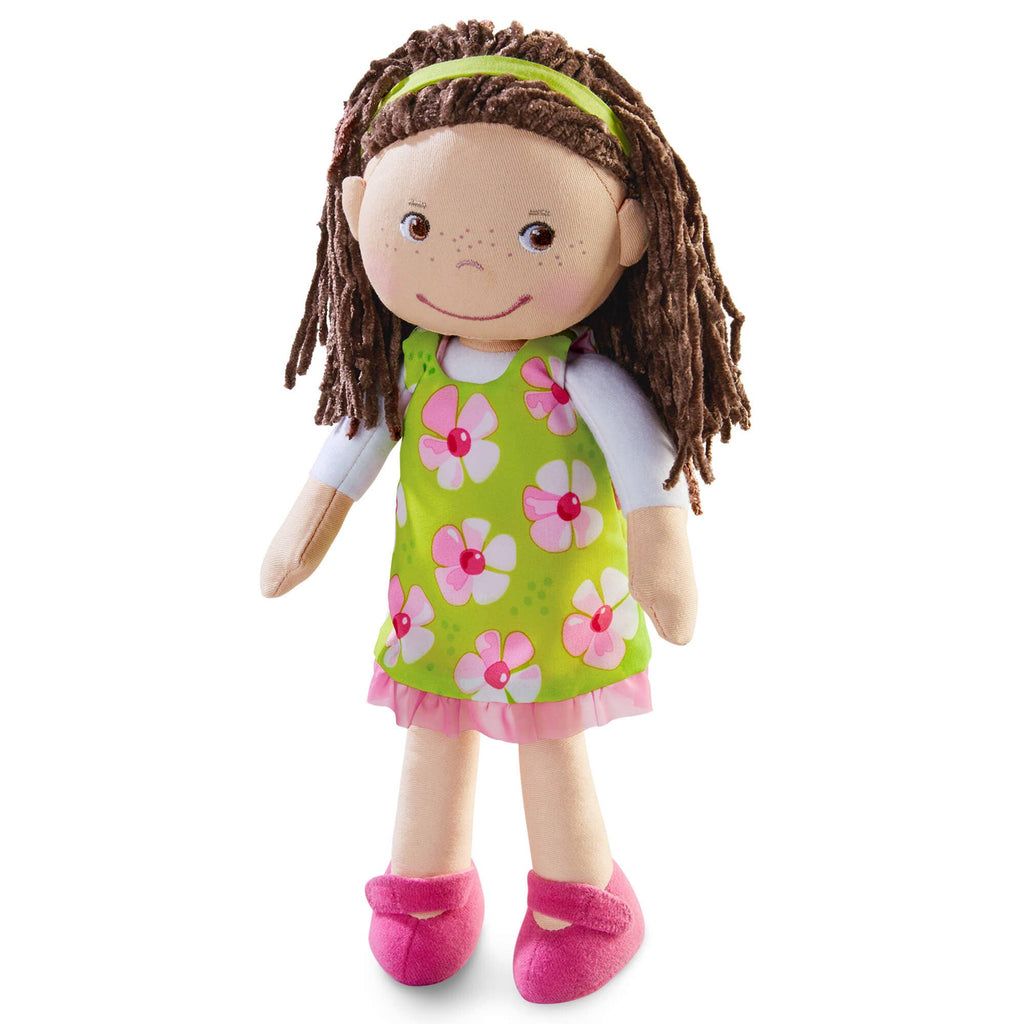 Plush doll with brown hair, green dress with pink flowers, and pink shoes on a white background