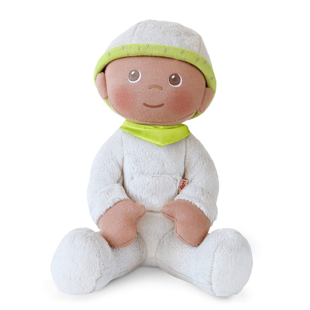 Plush baby doll with a green hat and bib on a white background