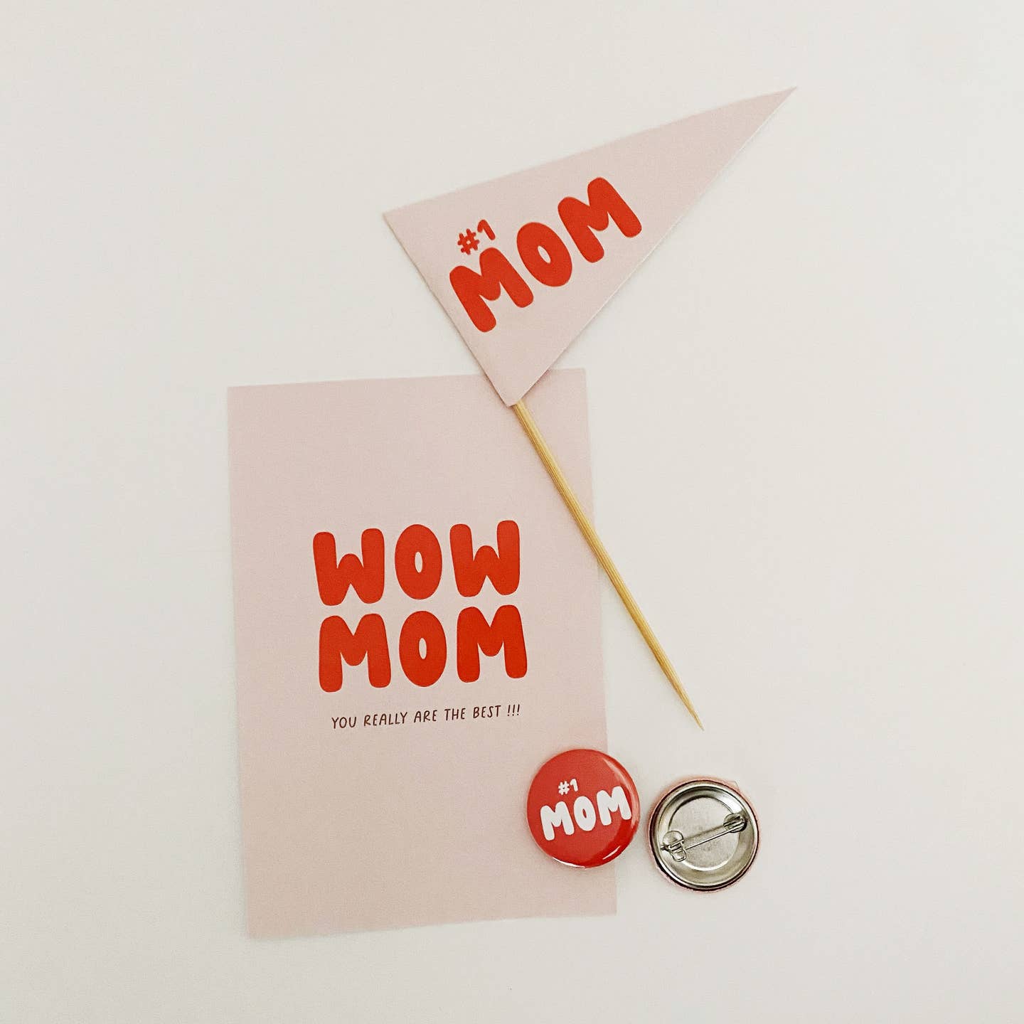 Mother's Day-themed items including a card, flag, buttons, and a pencil on a white background.