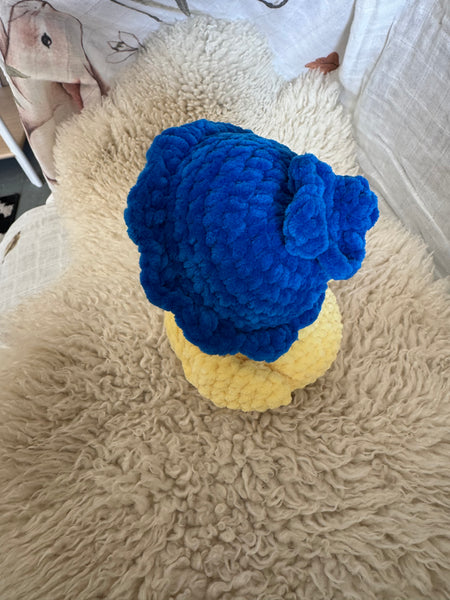 Blue and yellow knitted hat on a textured surface