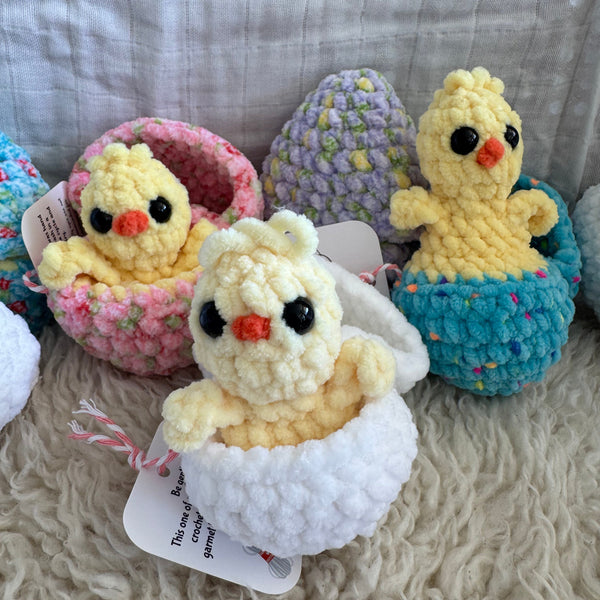 Colorful plush toys with chicks on a textured fabric background