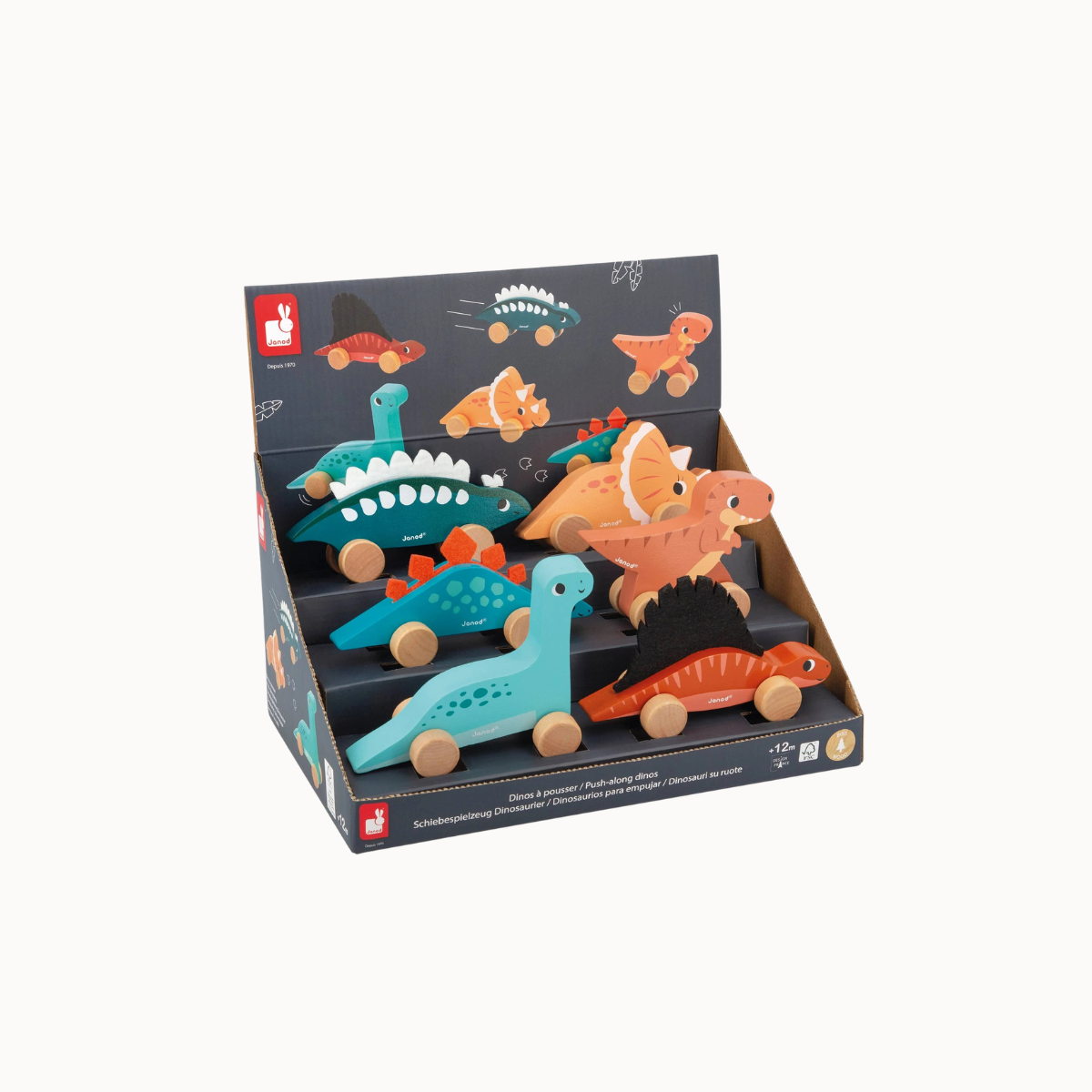 A set of wooden dinosaur toy cars displayed inside a branded retail box on a light gray background. The set includes several colorful dinosaur figures in teal, orange, red, and black, with natural wood wheels.